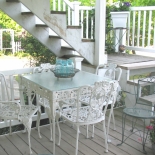 lower level patio with white table and chairs
